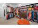 Large walk-in closet with custom built-ins, rod hangers, and plentiful shelving at 417 Westbury Dr, Chapel Hill, NC 27516