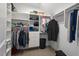 A well organized walk in closet with shelves and bars full of clothes and other items at 417 Westbury Dr, Chapel Hill, NC 27516