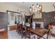 Elegant dining room featuring a dark wood table, decorative chandeliers, and paneled walls at 417 Westbury Dr, Chapel Hill, NC 27516