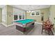 Bright game room featuring a billiard table, a large window, and natural light at 417 Westbury Dr, Chapel Hill, NC 27516