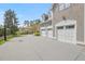 Spacious three-car garage featuring white doors and a large driveway, complemented by well-maintained landscaping at 417 Westbury Dr, Chapel Hill, NC 27516