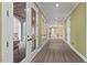 Long hallway with hardwood floors, recessed lighting, and multiple doors to the exterior at 417 Westbury Dr, Chapel Hill, NC 27516
