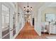 Spacious hallway with hardwood floors, elegant lighting, and access to multiple rooms at 417 Westbury Dr, Chapel Hill, NC 27516