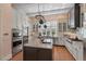 Gourmet kitchen with stainless steel appliances, custom cabinets, and a granite island at 417 Westbury Dr, Chapel Hill, NC 27516