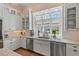 Bright kitchen area with white cabinets, stainless appliances, and a view to a well-manicured backyard at 417 Westbury Dr, Chapel Hill, NC 27516