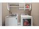 Convenient laundry room with modern washer, dryer, and built-in shelving at 417 Westbury Dr, Chapel Hill, NC 27516