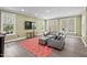 Open living room features a flat-screen TV, recessed lighting, and large windows at 417 Westbury Dr, Chapel Hill, NC 27516