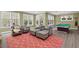 Spacious living room features comfortable seating, large windows, and a billiard table at 417 Westbury Dr, Chapel Hill, NC 27516