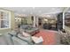 Open-concept living room with seating, a billiard table, a kitchen, and staircase at 417 Westbury Dr, Chapel Hill, NC 27516