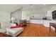 Open-concept living and dining area with hardwood floors, a modern kitchen, and comfortable seating at 417 Westbury Dr, Chapel Hill, NC 27516