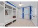 A mudroom with blue accents features white cabinets and drawers and a door to the exterior at 417 Westbury Dr, Chapel Hill, NC 27516