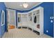 A mudroom with blue accents features white corner cabinets and drawers and tile floors at 417 Westbury Dr, Chapel Hill, NC 27516