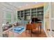 Well-lit office space with custom built-ins, a grand piano, and a view of the outdoors at 417 Westbury Dr, Chapel Hill, NC 27516