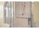 Modern shower with white tiled walls, glass door, and a convenient handrail at 417 Westbury Dr, Chapel Hill, NC 27516