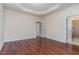 Spacious bedroom featuring a tray ceiling, wood floors, and access to the bathroom at 452 Panorama Park Pl, Cary, NC 27519