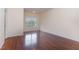 Inviting bedroom featuring hardwood floors and a large window for natural light and outdoor views at 452 Panorama Park Pl, Cary, NC 27519