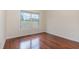 Well-lit bedroom with hardwood floors and a window providing a view of the neighborhood at 452 Panorama Park Pl, Cary, NC 27519
