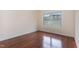 Bright bedroom with hardwood floors and a window with view to the community and natural light at 452 Panorama Park Pl, Cary, NC 27519
