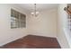 Dining room with hardwood floors, white trim, and natural light from a large window at 452 Panorama Park Pl, Cary, NC 27519