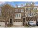 Beautiful brick townhome featuring an attached garage, a small portico, and tasteful landscaping at 452 Panorama Park Pl, Cary, NC 27519