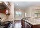 Bright kitchen features granite countertops, stainless steel appliances, and hardwood flooring at 452 Panorama Park Pl, Cary, NC 27519