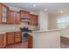 Well-equipped kitchen with granite countertops, stainless steel appliances, and cherry wood cabinets at 452 Panorama Park Pl, Cary, NC 27519