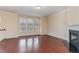 Spacious living room with hardwood floors, fireplace, and large windows for natural light at 452 Panorama Park Pl, Cary, NC 27519