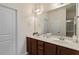 Bright bathroom featuring a double vanity, large mirror, and glass enclosed shower at 4712 Bright Pebble Ct, Raleigh, NC 27604