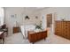 Cozy bedroom features a four-poster bed, wood furniture, and an attached bathroom at 4712 Bright Pebble Ct, Raleigh, NC 27604
