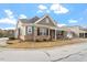 Charming home featuring brick accents, a covered porch, and landscaped yard at 4712 Bright Pebble Ct, Raleigh, NC 27604