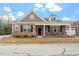 Charming single-story home with brick and gray siding, covered porch, and well-maintained landscaping at 4712 Bright Pebble Ct, Raleigh, NC 27604