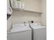 A well-equipped laundry room featuring a washer and dryer and plenty of storage at 4712 Bright Pebble Ct, Raleigh, NC 27604