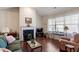 Cozy living room boasts a fireplace, hardwood floors, and lots of natural light from bright windows at 4712 Bright Pebble Ct, Raleigh, NC 27604