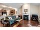 Open-concept living area featuring hardwood floors, a cozy fireplace, and seamless flow to the kitchen at 4712 Bright Pebble Ct, Raleigh, NC 27604