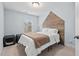 Bedroom with wooden accent wall, soft natural light, and neutral décor, a tranquil retreat at 5 Galway Glenn Ln, Durham, NC 27705