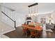 Cozy dining area next to a staircase and a view of a fireplace and tv at 5 Galway Glenn Ln, Durham, NC 27705