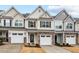 Charming exterior featuring stone accents and multiple garage doors adding curb appeal at 5 Galway Glenn Ln, Durham, NC 27705