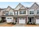 Inviting townhome exteriors with stone accents, garages and landscaped front yards at 5 Galway Glenn Ln, Durham, NC 27705