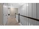 Hallway with wood railing and white wall accents, creating a stylish and well-lit passageway at 5 Galway Glenn Ln, Durham, NC 27705