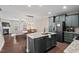 Open-concept kitchen featuring a large island, modern appliances, and hardwood flooring at 5 Galway Glenn Ln, Durham, NC 27705