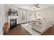 Cozy living room featuring a fireplace, ceiling fan and hardwood floors at 5 Galway Glenn Ln, Durham, NC 27705