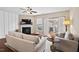 Bright living room featuring a fireplace, ceiling fan, and sliding glass doors leading to outdoor space at 5 Galway Glenn Ln, Durham, NC 27705