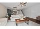 The light-filled living room offers stairs and a view into the modern kitchen with stylish lighting at 5 Galway Glenn Ln, Durham, NC 27705