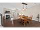 Living room with fireplace, large windows, ceiling fan, hardwood floors and adjacent dining area at 5 Galway Glenn Ln, Durham, NC 27705