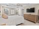 The primary bedroom has a tray ceiling, windows, and a mounted TV at 5 Galway Glenn Ln, Durham, NC 27705