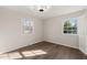 Bright bedroom features hard wood floors and two large windows with backyard views at 5013 Green Oak Dr, Durham, NC 27712