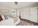 Bright bedroom features wood floors, white walls, accent rug, and ensuite bathroom at 5013 Green Oak Dr, Durham, NC 27712