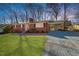 Beautiful brick home featuring a carport, lovely front yard, and a stone driveway at 5013 Green Oak Dr, Durham, NC 27712