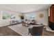 Spacious living room filled with natural light, brick fireplace and hardwood floors at 5013 Green Oak Dr, Durham, NC 27712