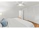 A neutral bedroom features hardwood floors, a ceiling fan, and closet at 506 N Greensboro St # Apt 33, Carrboro, NC 27510